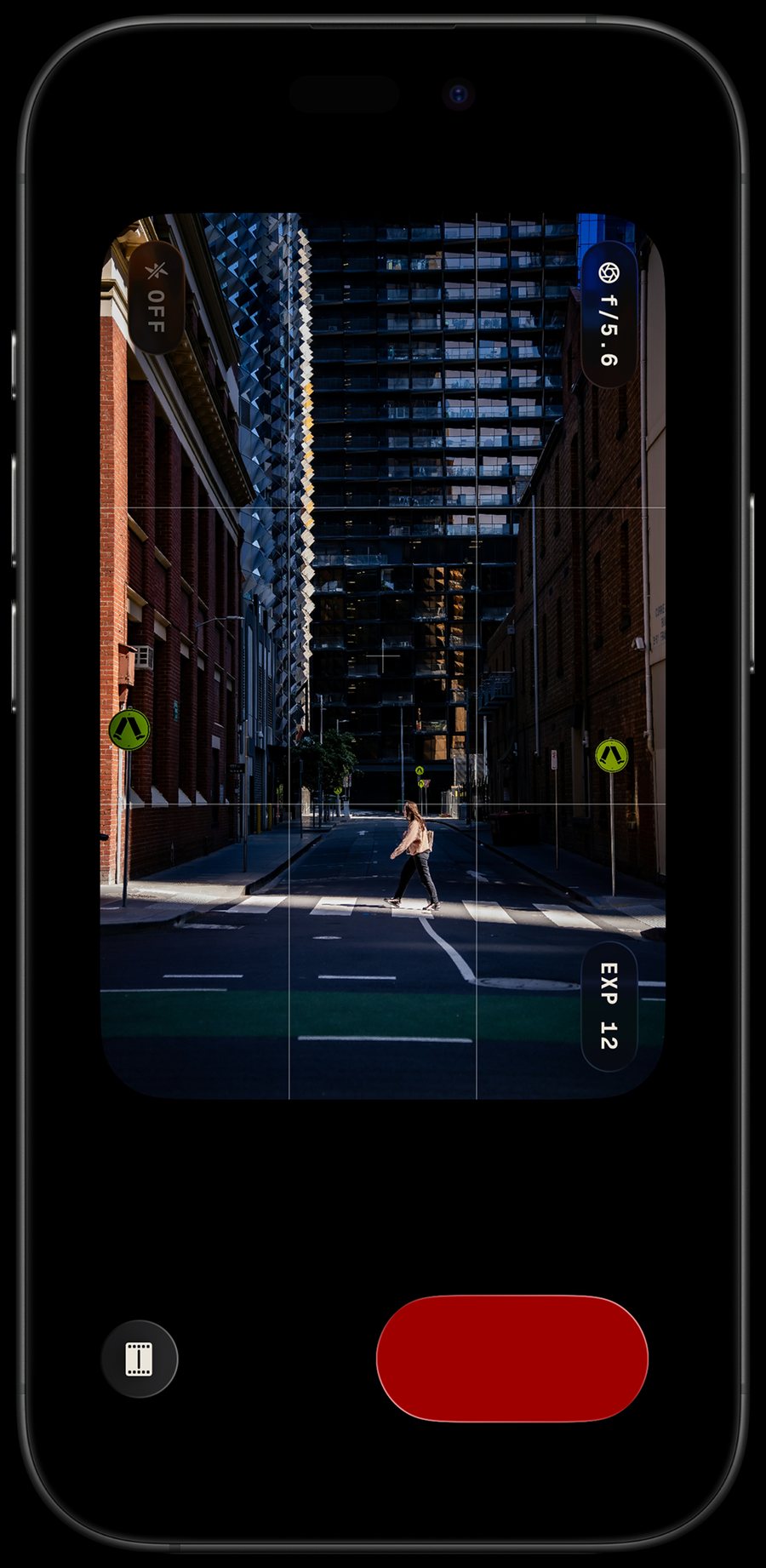 Lupo running on an iPhone held upright, the viewfinder showing a laneway between a brick wall and a glass tower, with a red shutter below.
